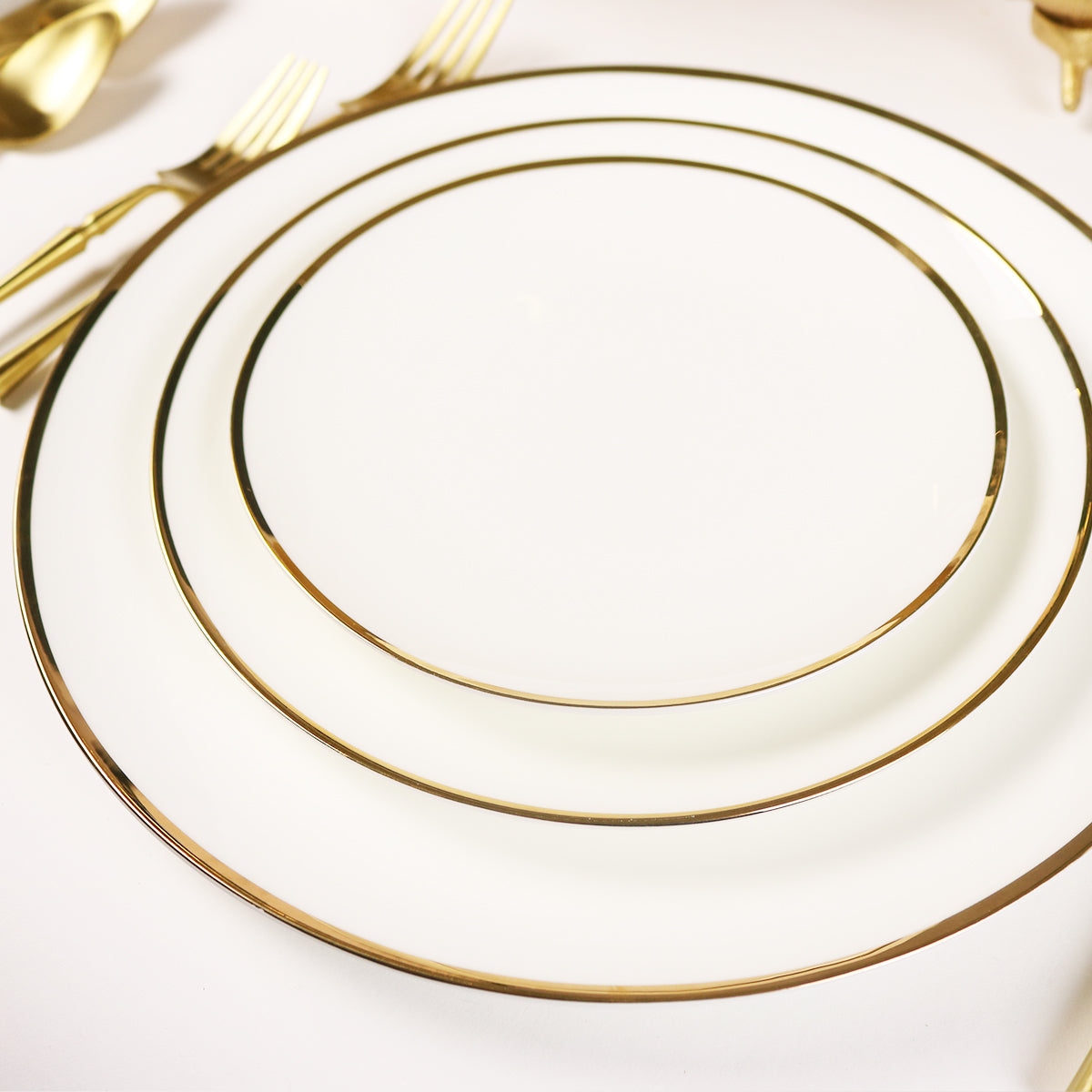 Elegant 16-piece white porcelain dinnerware set with a slim gold rim and glossy finish.