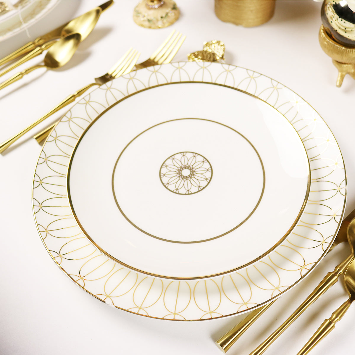Set of 4 white porcelain salad plates with raised medallion detail around the rim.