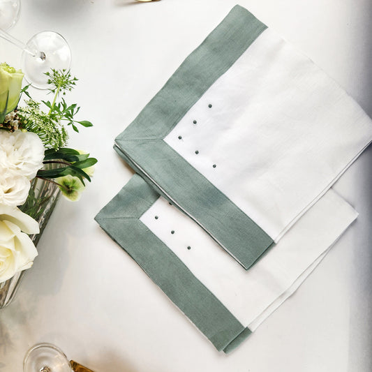 Set of 4 white Belgian linen napkins with mint green border and dots.